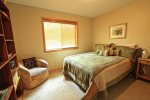 Main level bedroom with a queen bed